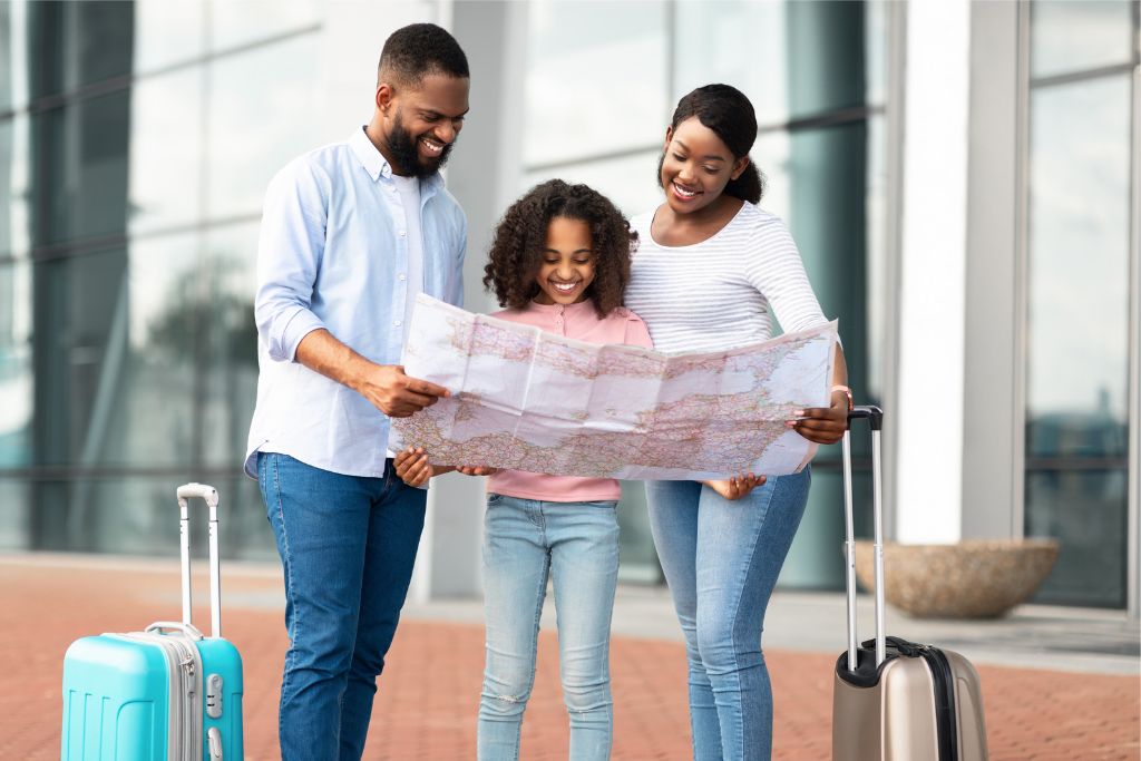 traveling with kids parents and child looking at a map at the airport